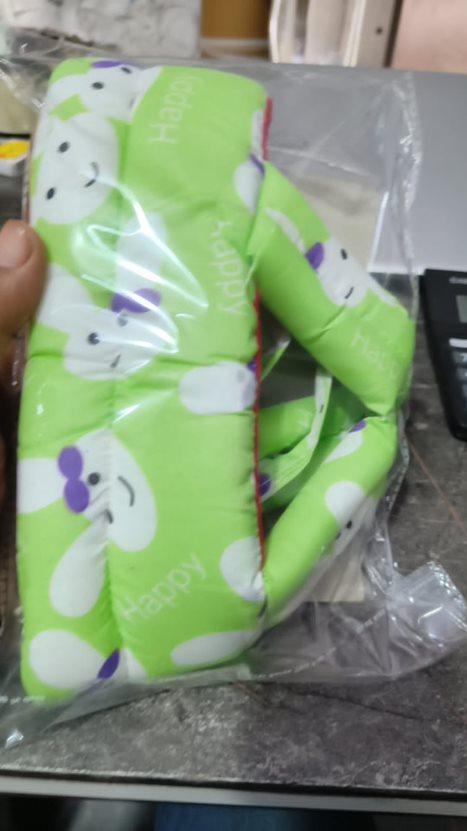 Green gloves with cartoon character design on a reflective surface